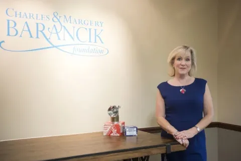 Caroline Guthrie standing next to a table