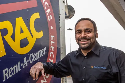 a man standing next to a sign