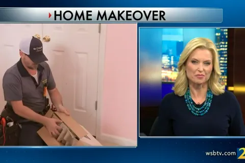 Linda Stouffer holding a paper and a man holding a paper