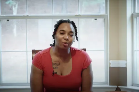 a woman in a pink shirt