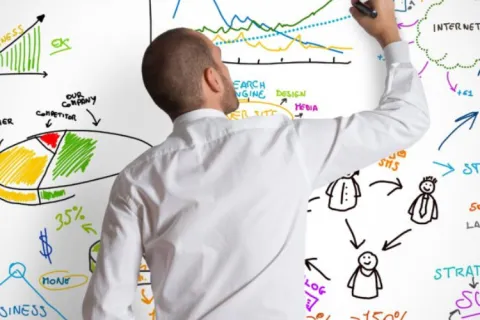 a person writing on a whiteboard