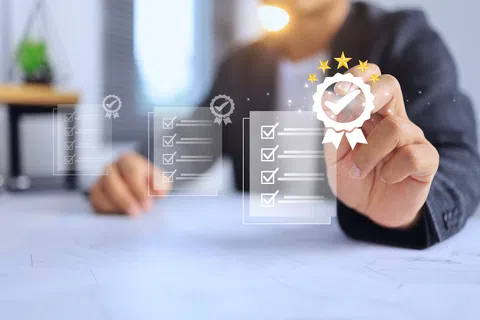 Person pointing at a virtual checklist with a checkmark badge symbolizing quality approval and certification.