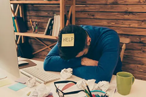 a person sleeping on a desk