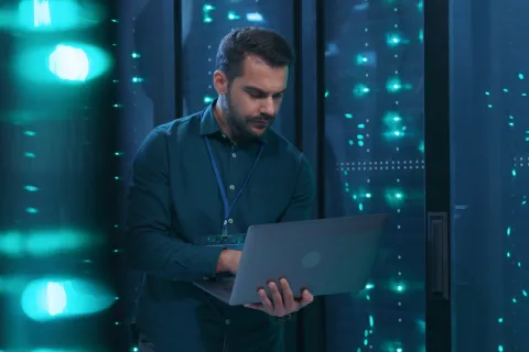 a man holding a laptop