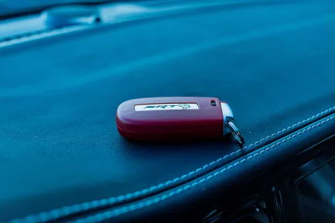 a red cell phone on a black surface