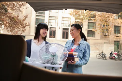 a few women looking at a laptop