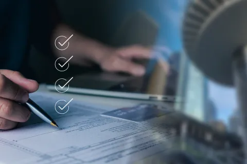 a person writing on a piece of paper