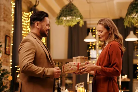 a man and woman holding a box