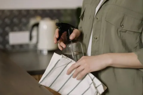 a person holding a cup and a paper
