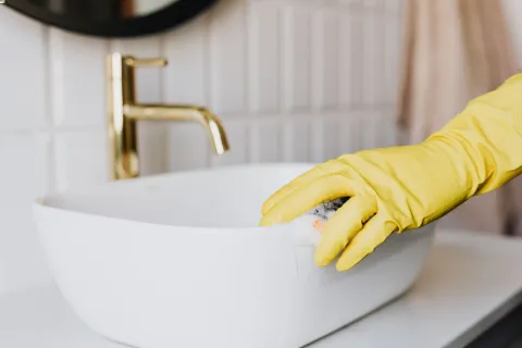 a person cleaning a sink