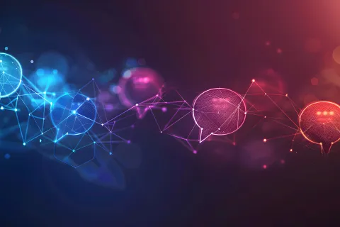 Digital chat bubbles connected by network lines in blue and red hues on a dark background depicting communication.