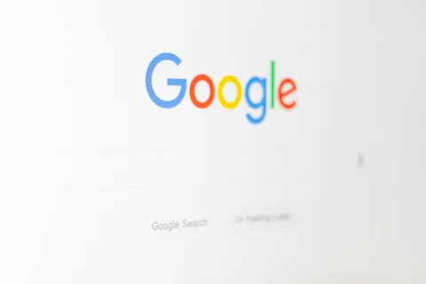 Google homepage with colorful logo and search bar on a white background focused on the brand name.