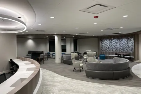 a room with a large round table and chairs