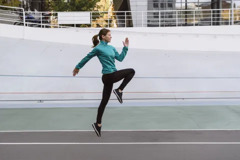a woman running on a track
