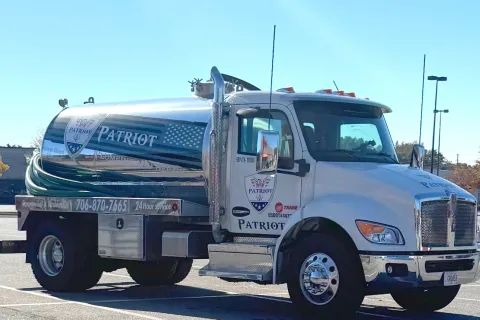 White Patriot branded tanker truck parked in a lot with clear blue sky overhead in northeast Georgia.