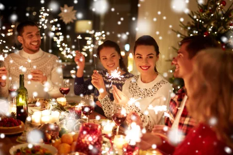 a group of people around a table with food and drinks