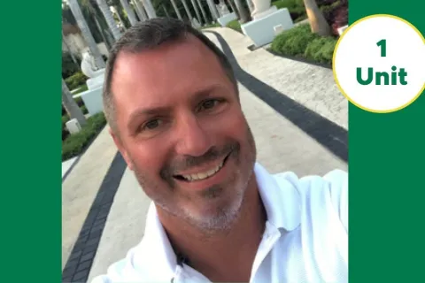 Smiling man in white shirt outdoors announcing new PestMaster franchise owners in Cleveland, Ohio.