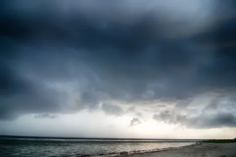 a beach with a cloudy sky