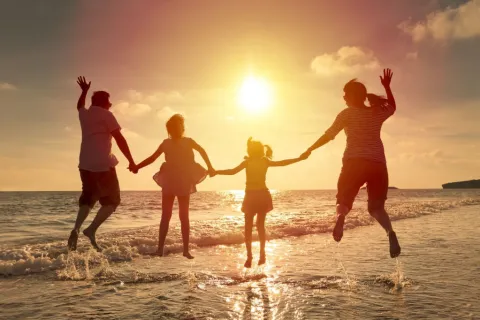 a family running on the beach
