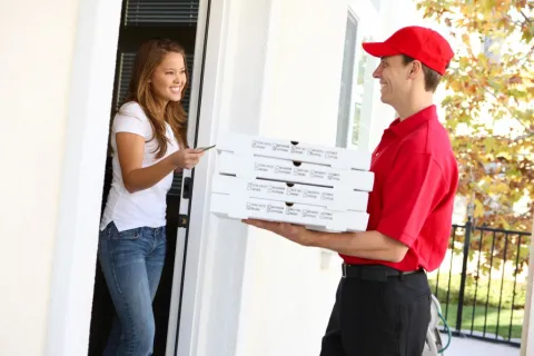 a man delivering a pizza
