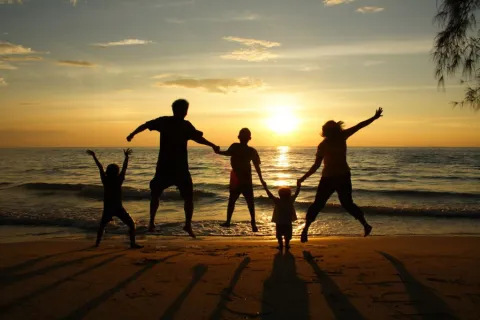 a group of people running on a beach
