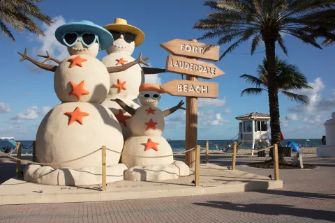 a couple of snowmen on a beach
