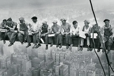 a group of men sitting on a roof