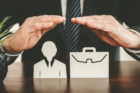 a person's hands holding cards