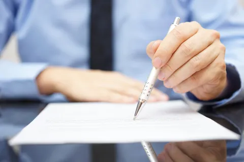 a person writing on a piece of paper