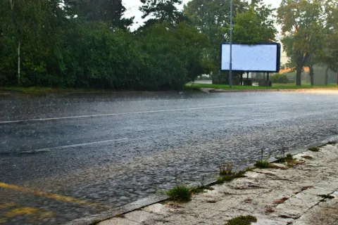 a flooded area with a billboard