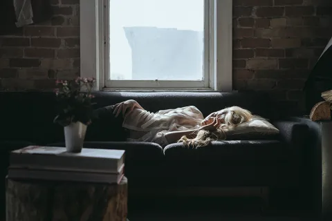 a person lying on a couch
