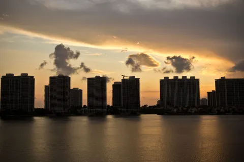 a city skyline with clouds in the sky