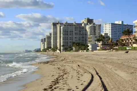 a beach with buildings along it