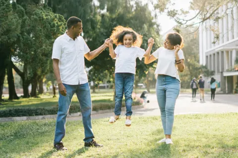 a group of people walking on a path in a park