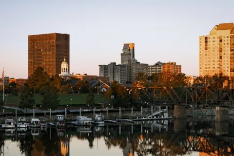 a body of water with boats in it and buildings in the back