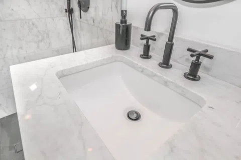 a bathtub with a faucet and a soap dispenser