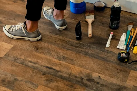a person standing on a wood floor