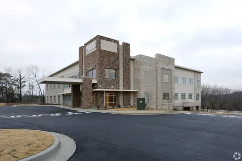 a large building with a parking lot