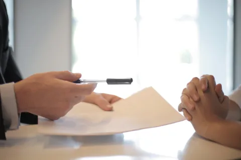 a person writing on a piece of paper