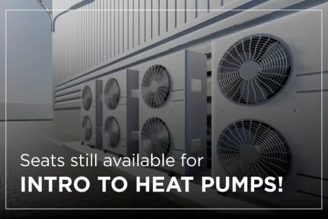 Multiple heat pump units mounted on a wall, promoting an introductory course on heat pumps.