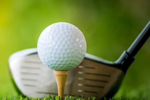a golf ball and a golf club