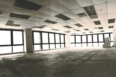 Empty spacious office interior with large windows and tiled ceiling ready for renovation or furnishing