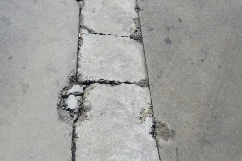 a sidewalk with a crack in it