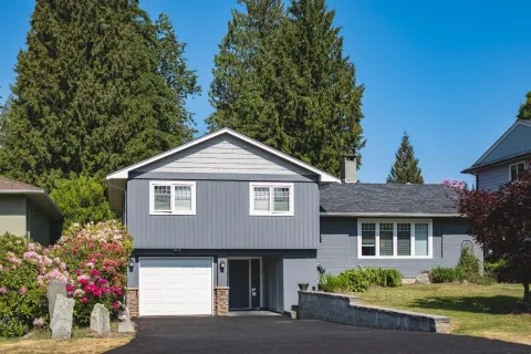 a house with a garage and trees