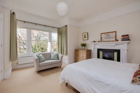 a bedroom with a fireplace