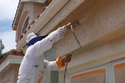 a person painting a building