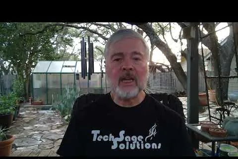 Man with gray beard speaking outdoors near greenhouse and potted plants in a garden patio setting