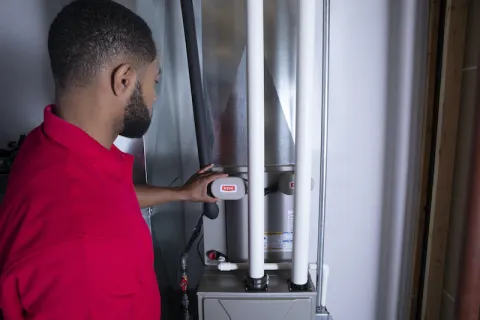 a man fixing a heat pump