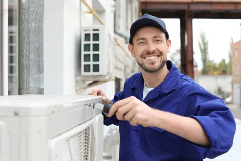 a man repairing an air conditioner