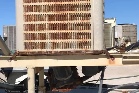 a dirty, old, rusty air conditioner